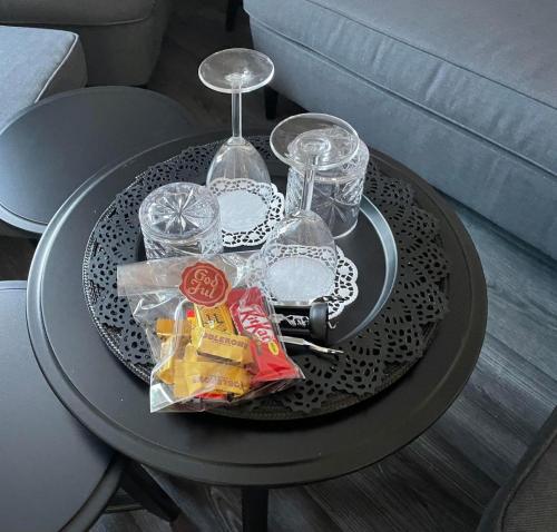 a black table with snacks and wine glasses on it at Brålanda Hotell och Vandrarhem in Brålanda
