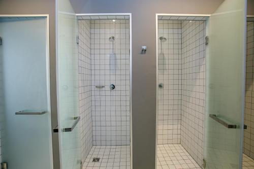 a bathroom with a walk in shower next to a toilet at Campus Community A-Hotel in Kyiv