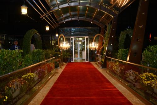 a red carpet leading into a greenhouse with plants at Ankawa Royal Hotel & Spa in Erbil