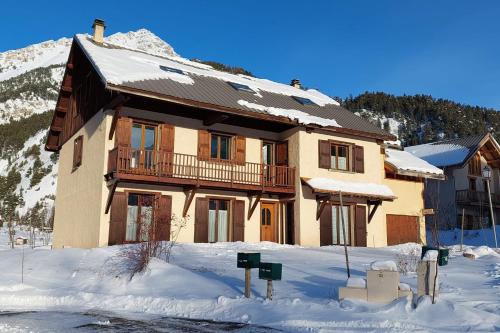 a large house in the snow with snow at Le Vallon des âmes - Large house for 15 people in Roubion in Névache