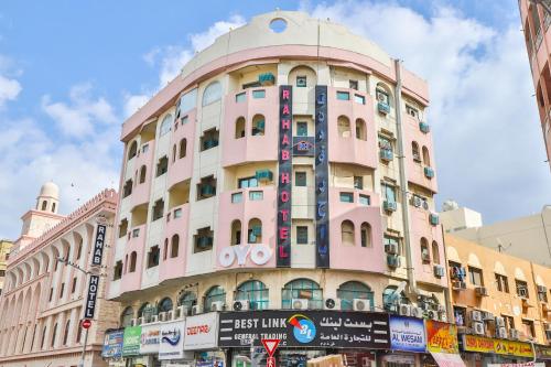 a pink building with a dome on top of it at Rahab Hotel in Dubai