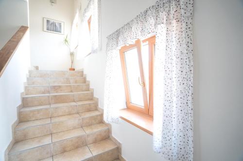 a staircase in a house with a window at Penzion Grado Davle in Davle
