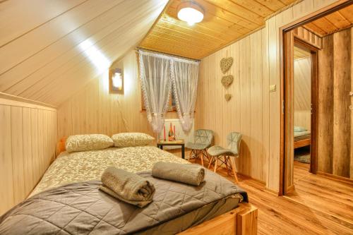 a bedroom with a bed in a room at Ostoja Bieszczady in Lutowiska
