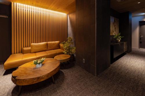 a living room with a couch and two tables at ROKA by HHG in Hakuba