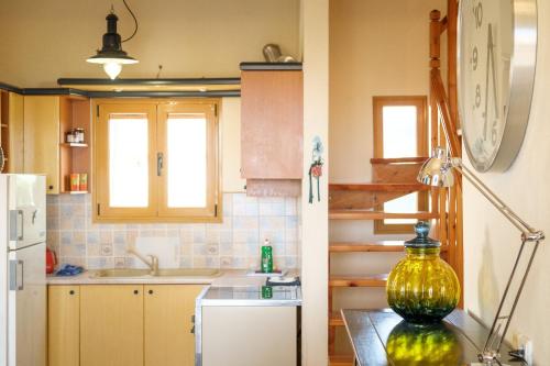 a kitchen with a large yellow vase on a table at Summer Home of Skaleta beach in Skaleta