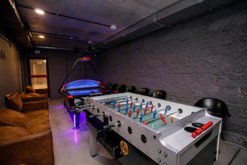 a ping pong table in a room with a couch at Campus Community A-Rooms in Kyiv