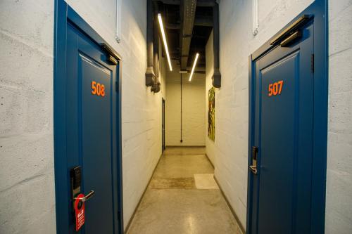 a corridor with blue doors in a hallway at Campus Community A-Rooms in Kyiv