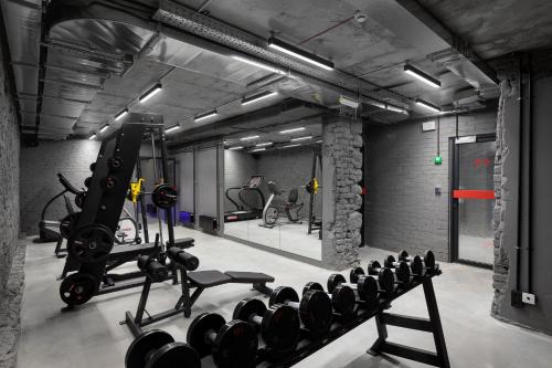 a gym with a lot of exercise equipment in it at Campus Community A-Rooms in Kyiv