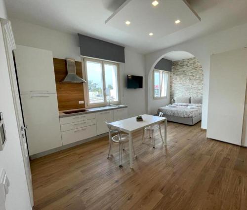 a kitchen and living room with a table and a couch at La Casa degli Artisti in Castel Maggiore