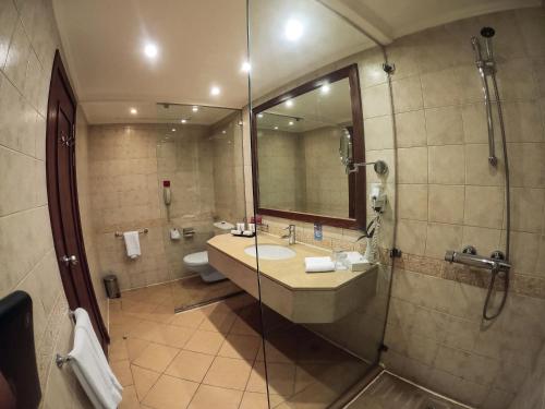 a bathroom with a sink and a shower at Mövenpick Resort Aswan in Aswan