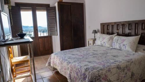 Ένα ή περισσότερα κρεβάτια σε δωμάτιο στο Casa Rural El Botánico