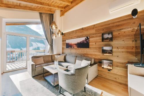 a living room with a couch and a table at Venediger Lodge in Neukirchen am Großvenediger