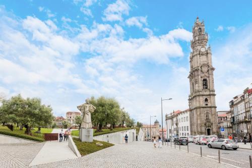 a city street with a clock tower in the background at Clérigos Tower - Experience in Porto in Porto