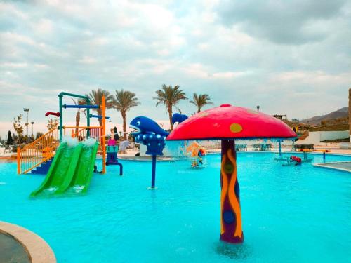 a water park with a playground with an umbrella in the water at Eastern El-Galala Aquapark Ain Sokhna in Ain Sokhna