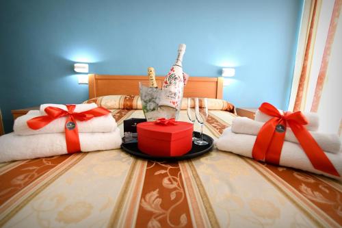 a bed with towels and presents on it with bows at International Resort in Mondragone