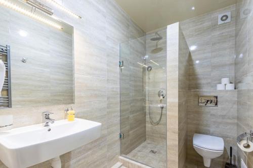 a bathroom with a sink and a shower and a toilet at Premium hotel & SPA in Bukovel