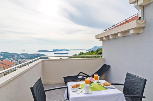 uma mesa e cadeiras numa varanda com vista em Apartments Villa Dadić em Dubrovnik