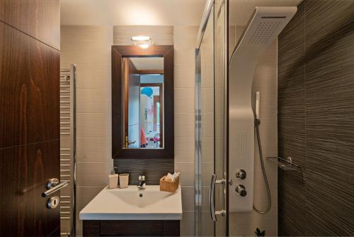 a bathroom with a sink and a mirror at Villa Ellovos with Private Pool in Rethymno Town