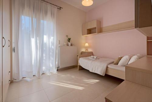 a bedroom with a bed and a large window at Villa Ellovos with Private Pool in Rethymno Town