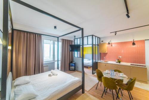 ein Schlafzimmer mit einem großen Bett und einem Tisch in der Unterkunft Manica R-House in Almaty