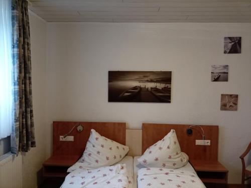 a hotel room with a bed and two pillows at Hotel An der Karlstadt in Bremerhaven