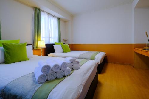 Ένα ή περισσότερα κρεβάτια σε δωμάτιο στο ケイアイコンホテルズ 新栄901