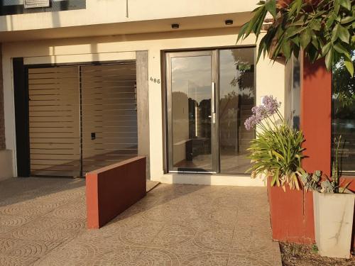 a house with a garage door and some plants at Arenas de Colón in Colón