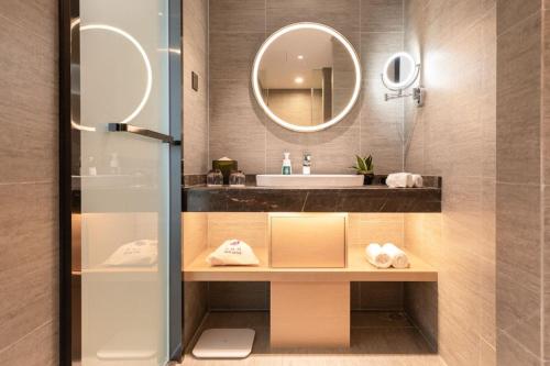 a bathroom with a sink and a mirror at Atour Light Hotel (Wuhan Wuchang Railway Station) in Wuhan