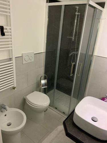 a bathroom with a shower and a toilet and a sink at La casa di Agnese in Orvieto