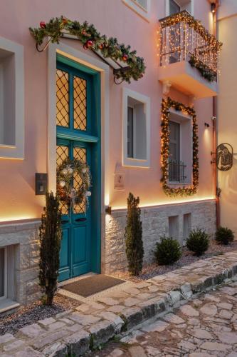 a house with a green door and christmas wreath at NAIADES the residence ioannina castle in Ioannina