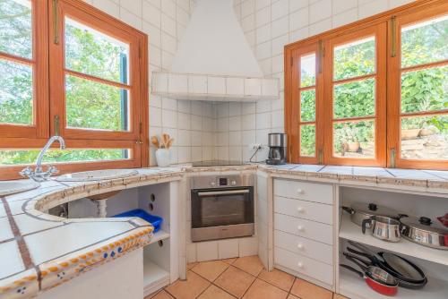 a kitchen with a sink and a stove at Finca Es Rafalot de Dalt by Mallorca House Rent in Manacor