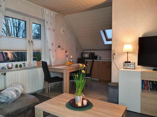 a living room with a table and a kitchen at Huus Borkum in Borkum