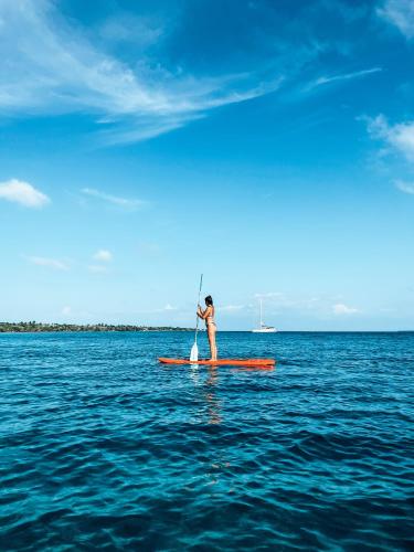 a person on a paddle board in the water at Santa Lova Eco-hostel Isla Tintipan in Tintipan Island