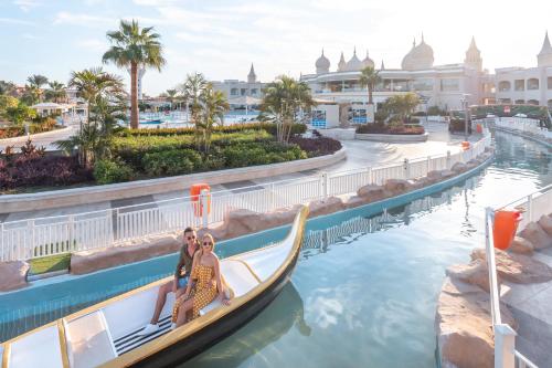 two women in a gondola in the water at a resort at Pickalbatros Aqua Blu Sharm El Sheikh in Sharm El Sheikh