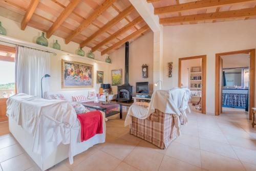 a living room filled with furniture and a wooden ceiling at Finca Puig de l'Anar in Manacor
