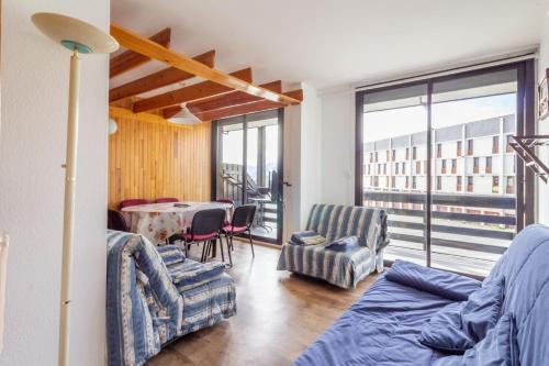 a living room with a couch and chairs and a table at L'Altitude - Appartement avec balcon au pied des pistes in Saint-Lary-Soulan