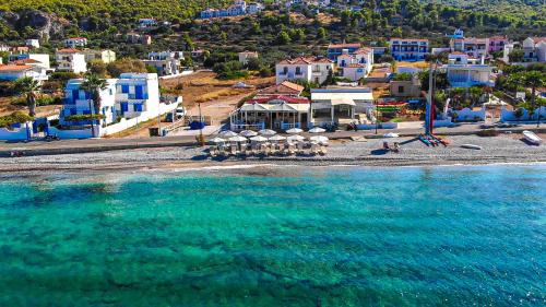 an aerial view of a beach with blue buildings and the water at Laza Beach in Skala
