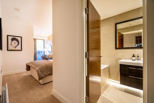 a bathroom with a sink and a bed in a room at The Residence @ Ryedale House in York