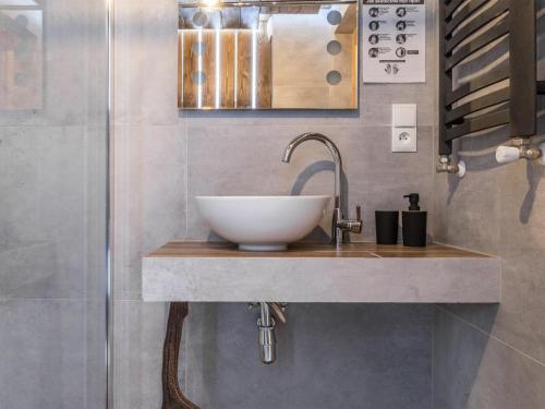 a bathroom with a bowl sink on a counter at Dom Tatrzański Ewa II in Kościelisko