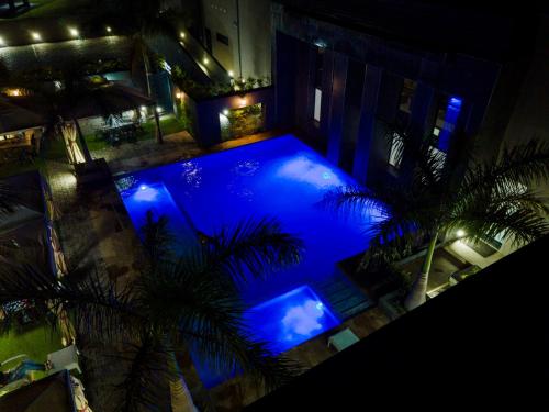 an overhead view of a swimming pool at night at Urban Bliss Hotel in Kabwe
