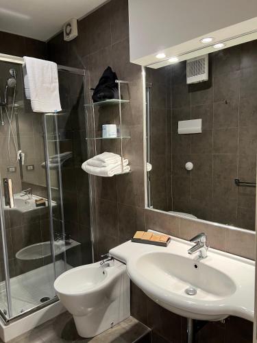 a bathroom with a sink and a glass shower at Residence San Martino in Messina