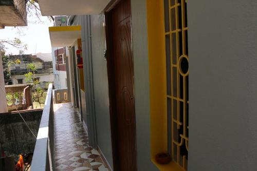 a hallway of a house with a door and a hallway at Paradise corner in Pondicherry
