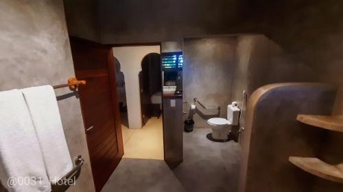 a small bathroom with a toilet and a sink at 0031 Boutique Hotel & Restaurant Cumbuco in Cumbuco