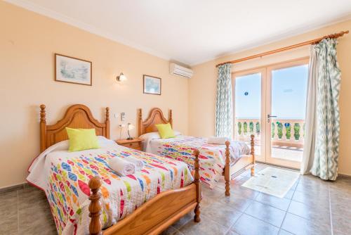 a bedroom with two beds and a balcony at Es Reguerons Gran in Felanitx