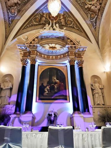 a table in a room with a painting on the ceiling at Abbaye des Capucins Spa & Resort in Montauban