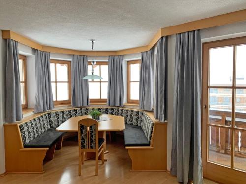 a dining room with a bench and a table at Pension Strolz in Sankt Anton am Arlberg