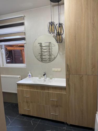 a bathroom with a sink and a mirror at Chalet Mlyn in Migovo