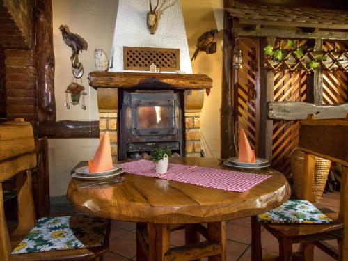 a room with a wooden table and a fireplace at Stara Vodenica in Klanjec