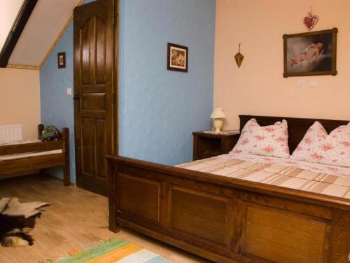 a bedroom with a large wooden bed with pink pillows at Stara Vodenica in Klanjec