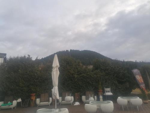 a umbrella and chairs and tables with a mountain in the background at Sonne in Halblech